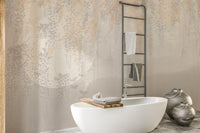 Grey botanical wall mural with metallic leaf accents in a minimalist bathroom.