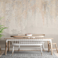 Dining space wall mural with hanging leaf patterns and a white bench.