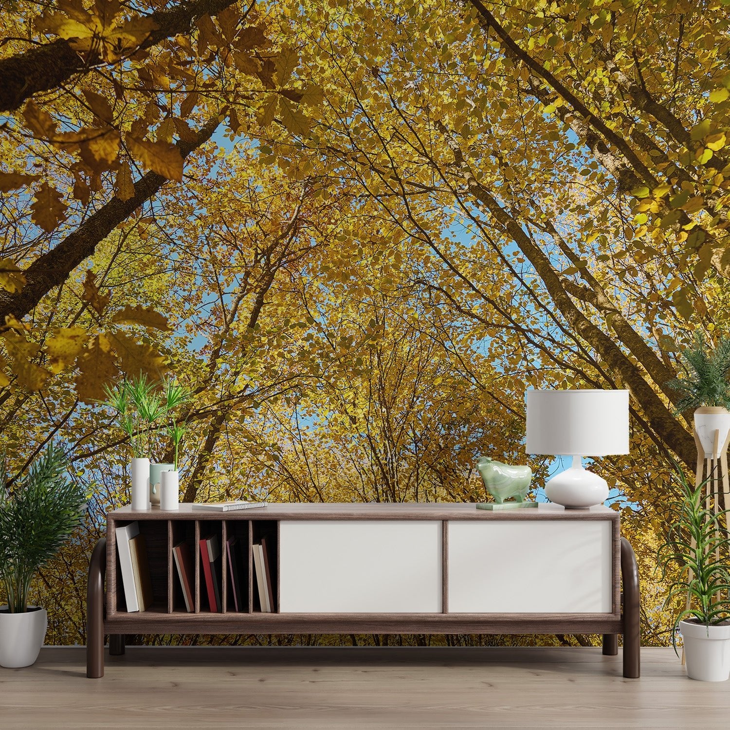 Golden autumn forest canopy wallpaper showing yellow leaves and blue sky.
