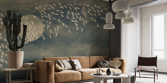 Golden Birds Flying Black Wall Mural in modern living room with tan sofa.