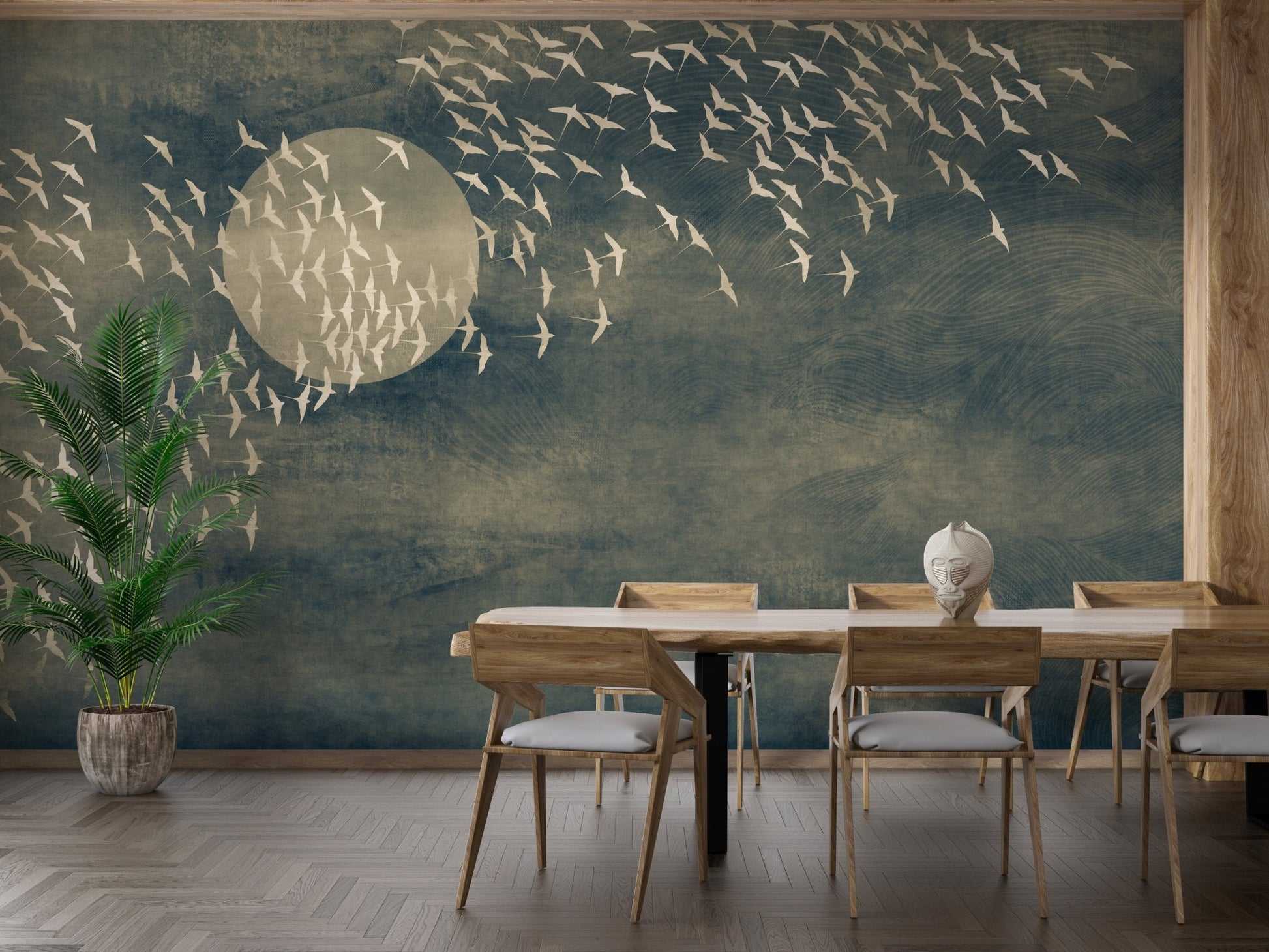 Moon and birds wall mural in dining room with wooden table and chairs.