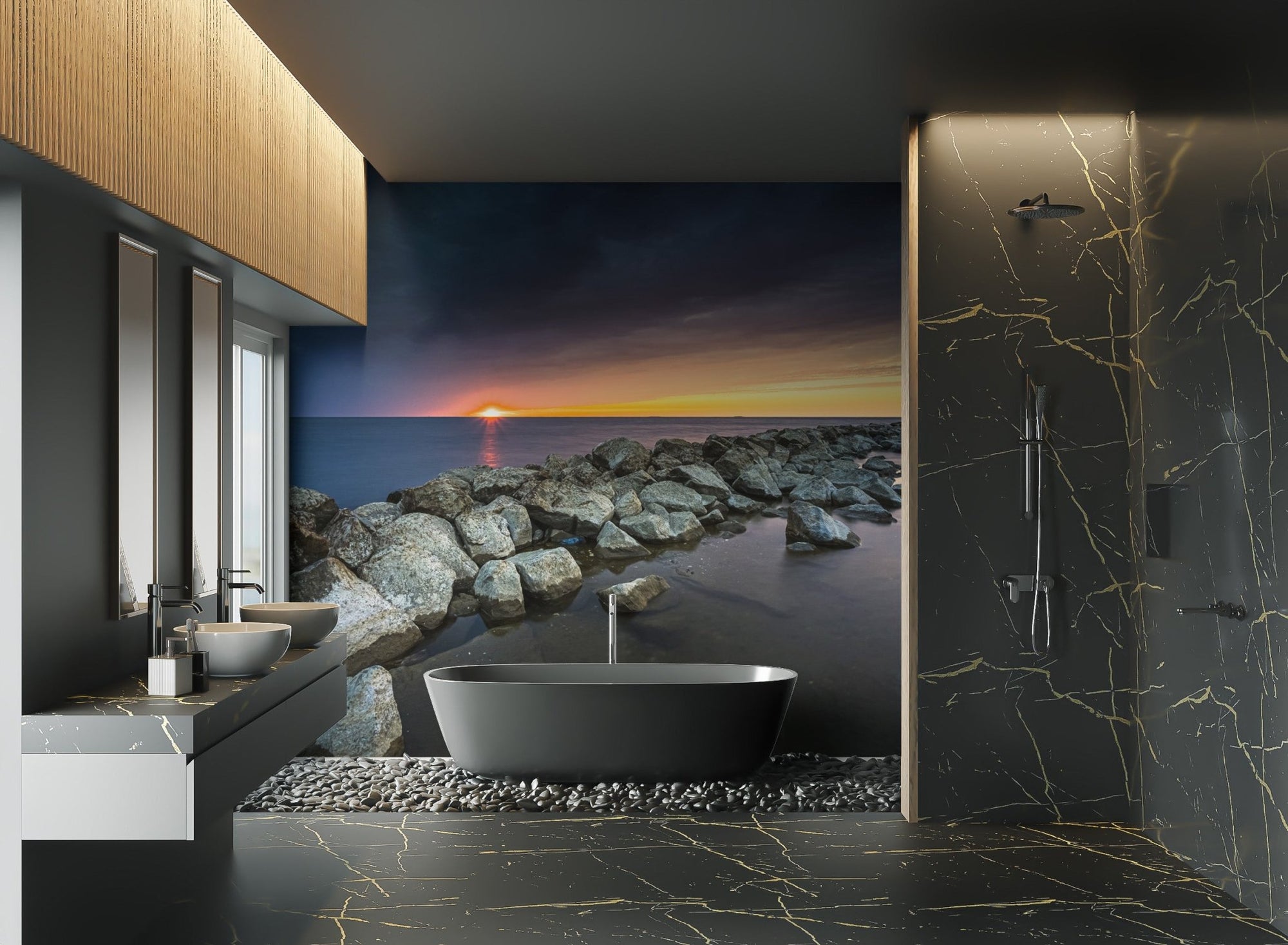 Sunset ocean wallpaper featuring rocky shoreline under a moody blue sky.