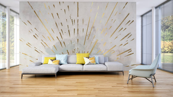 Sunburst design wall mural with gold leaf style rays on grey surface.