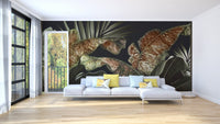 L-shaped white couch against a dark botanical leaves wall mural in an open floor plan.