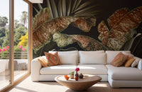Golden Tone Tropical Leaves Wall Mural behind a white sofa in a bright room.
