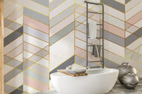 Luxury bathroom decor with marble chevron wall mural and metallic accents.