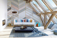 Living room attic space with chevron marble wall mural and white sofa.