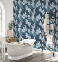 Waterproof mountain wallpaper in bathroom with white freestanding tub.