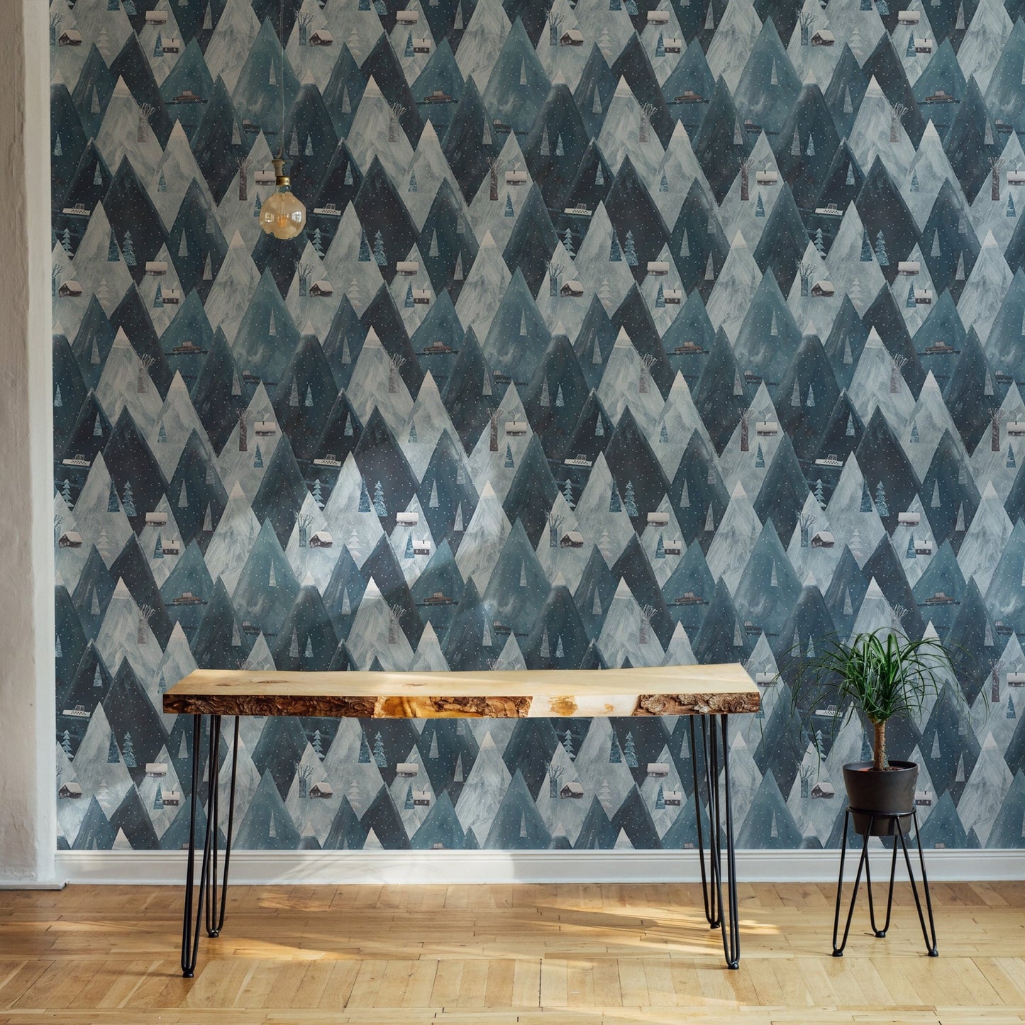 Blue mountain wallpaper behind a dark wood desk.