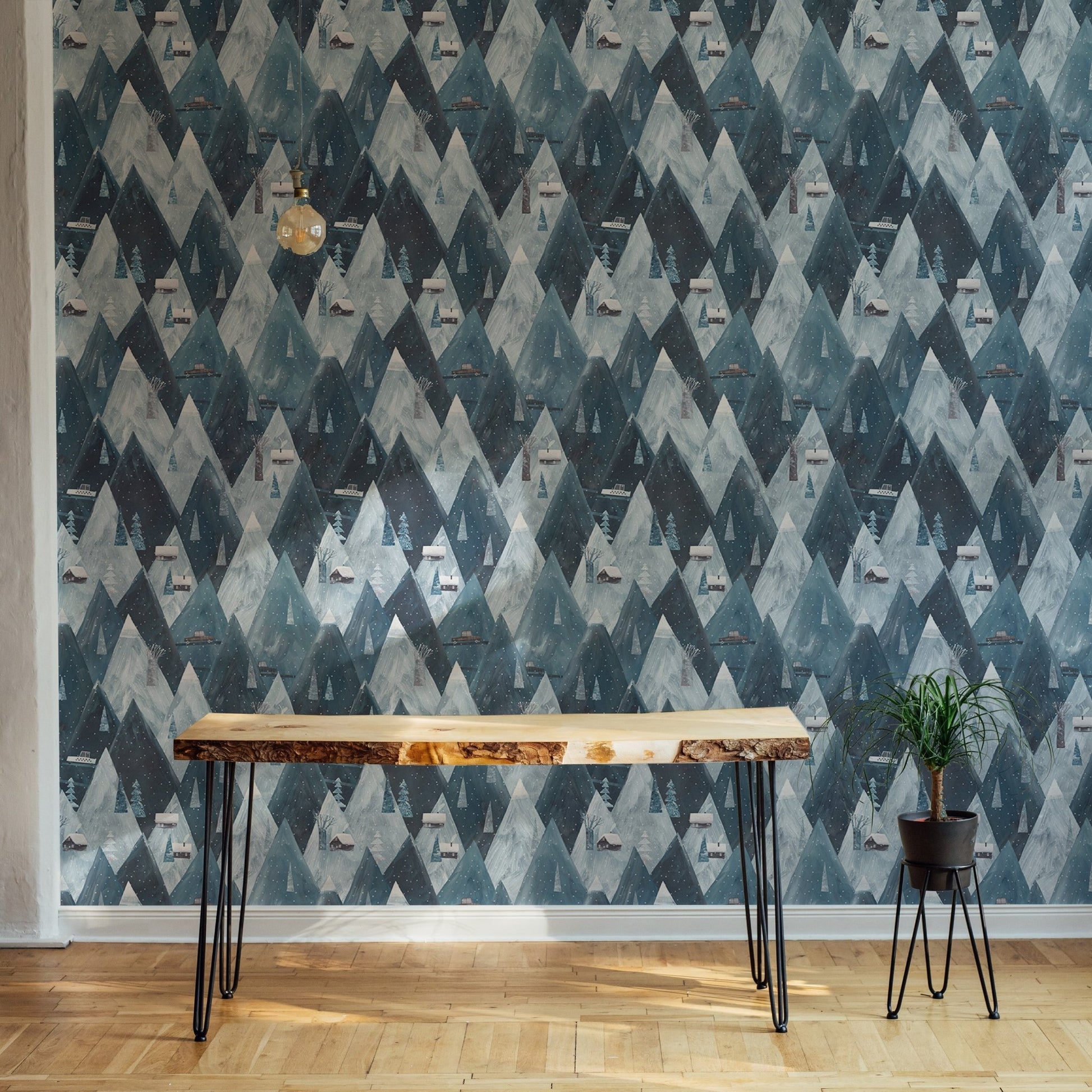 Blue mountain wallpaper behind a dark wood desk.