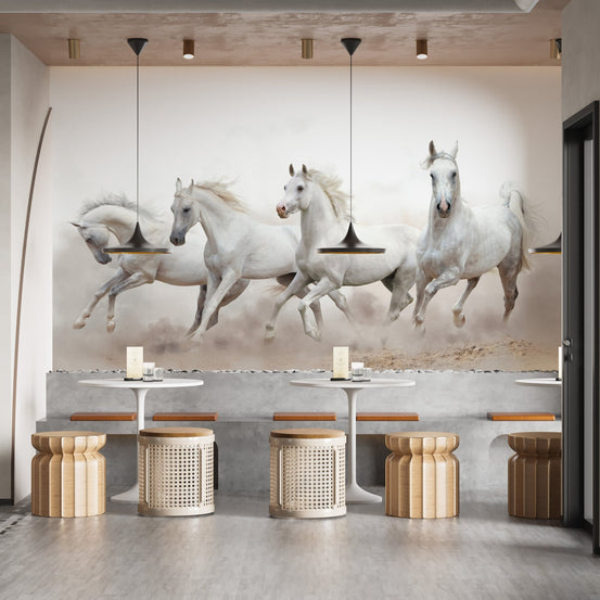 White running horses wall mural in a cafe with round tables and wooden stools.