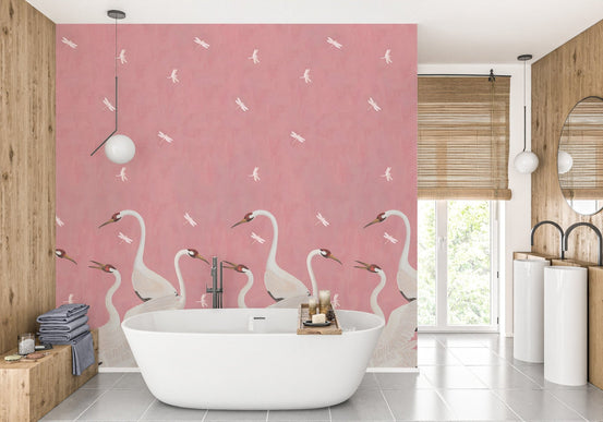 Modern bathroom with pink sakura wall mural and a white freestanding tub.