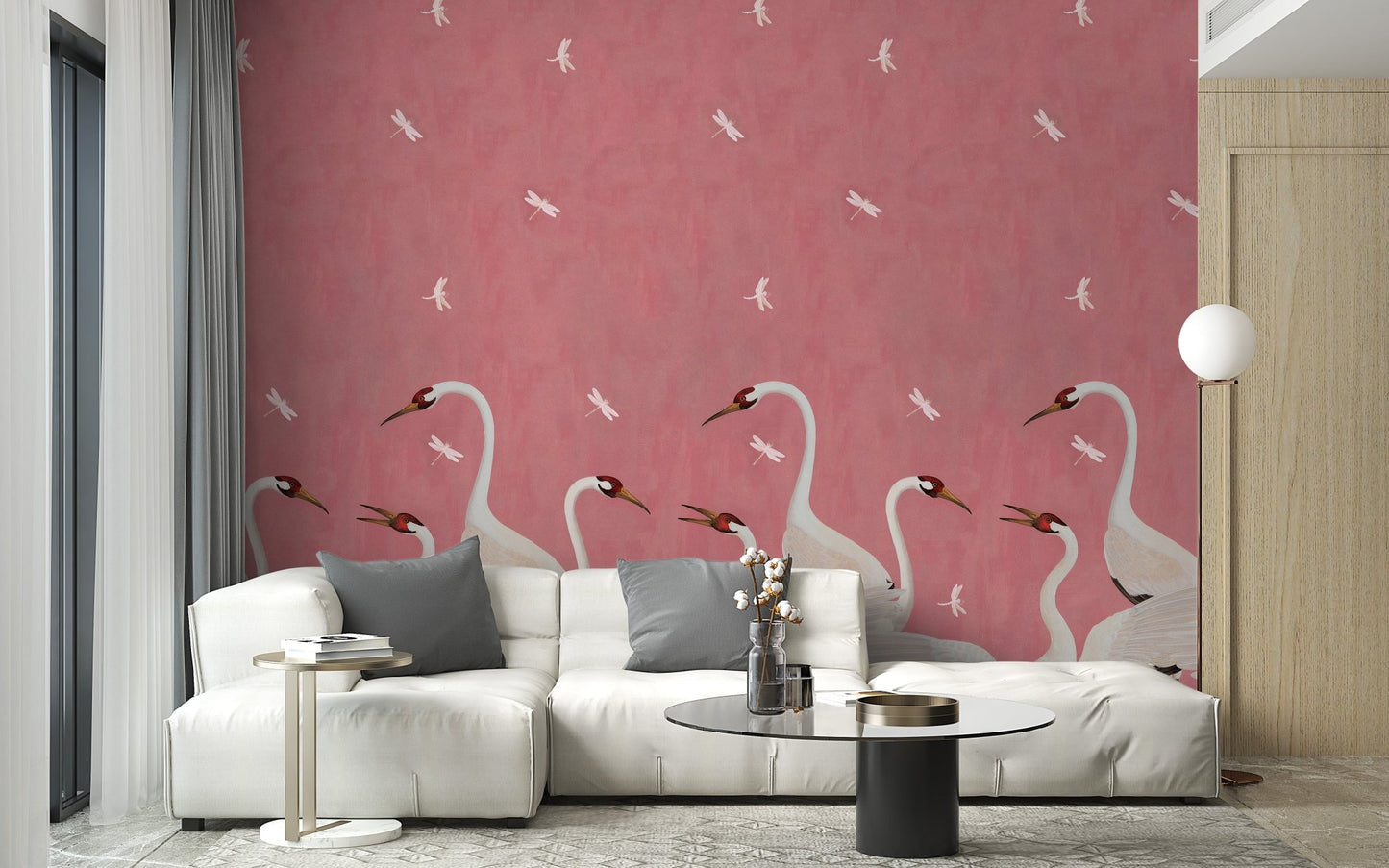 Graceful Sakura Soar Wall Mural in a bright living area with a white sectional sofa.