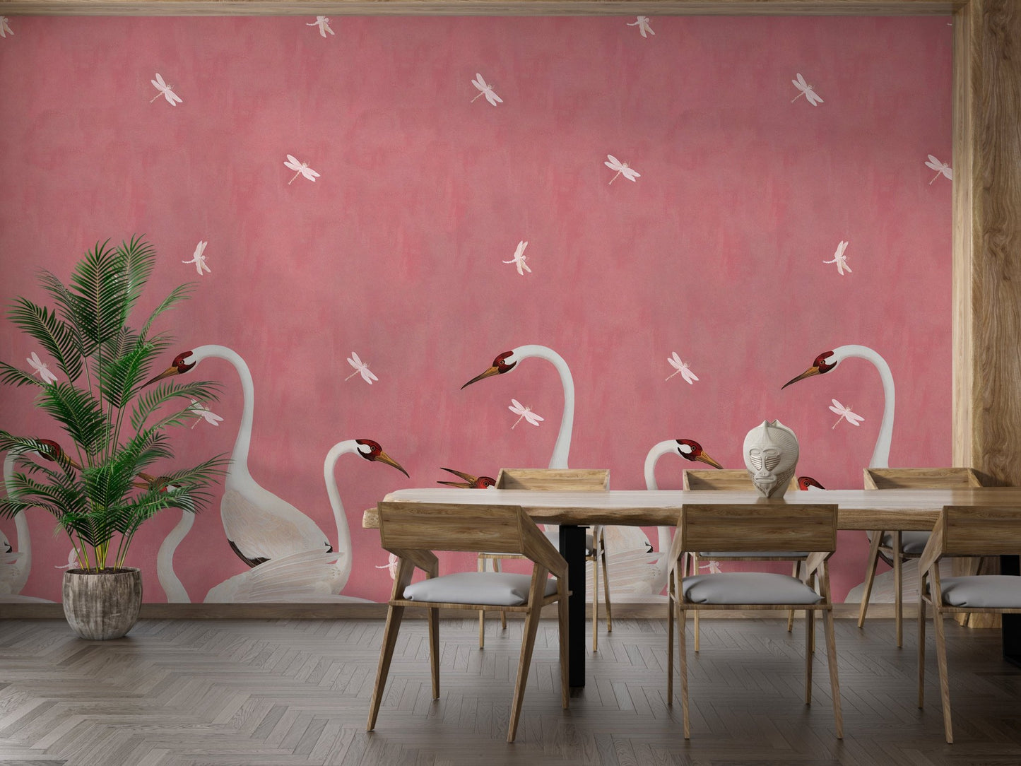 Graceful Sakura Soar Wall Mural in a dining area with wooden chairs and plants.