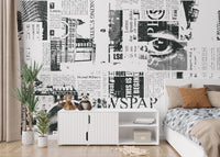 Grayscale newspaper collage wall mural with bold letter graphics.