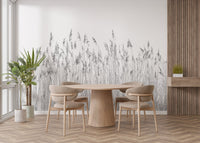Botanical breeze wall mural with reed patterns behind a wooden dining table and chairs.