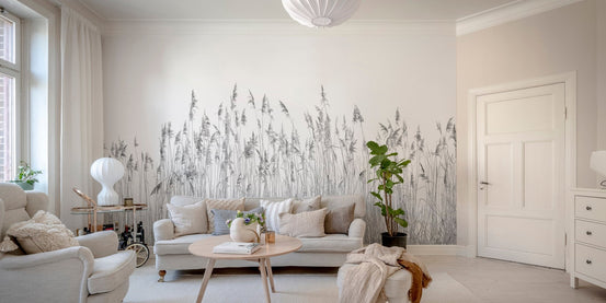 Minimalist gray wall mural in a living room with a beige sofa and wooden floor.