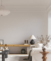 Living area with white sofa and gray diamonds pattern wallpaper.