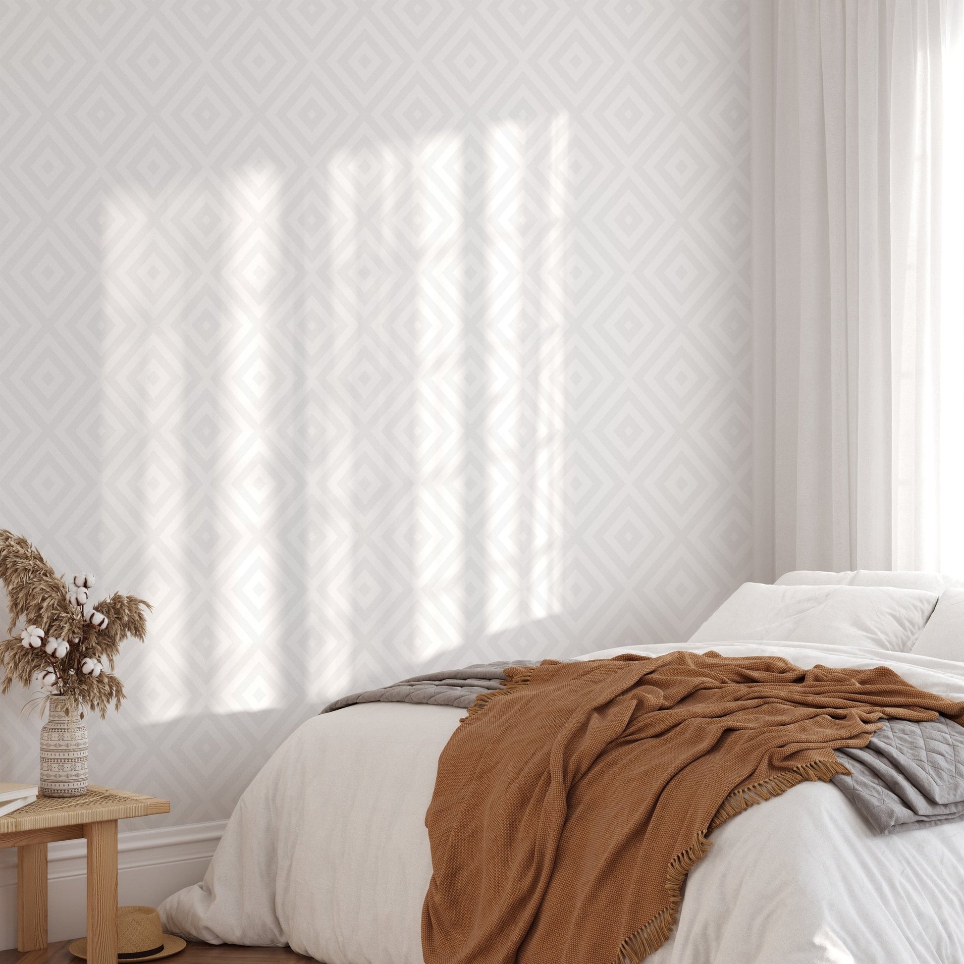 Sunlit bedroom featuring a textured gray geometric wallpaper behind the bed.