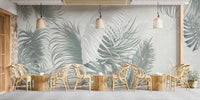 Sophisticated tropical palm leaves mural in dining area.