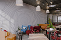 Minimalist grey wall mural with overlapping circular designs in cafe.