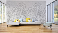 Grayscale palm and tropical leaf wall mural for open plan living room.
