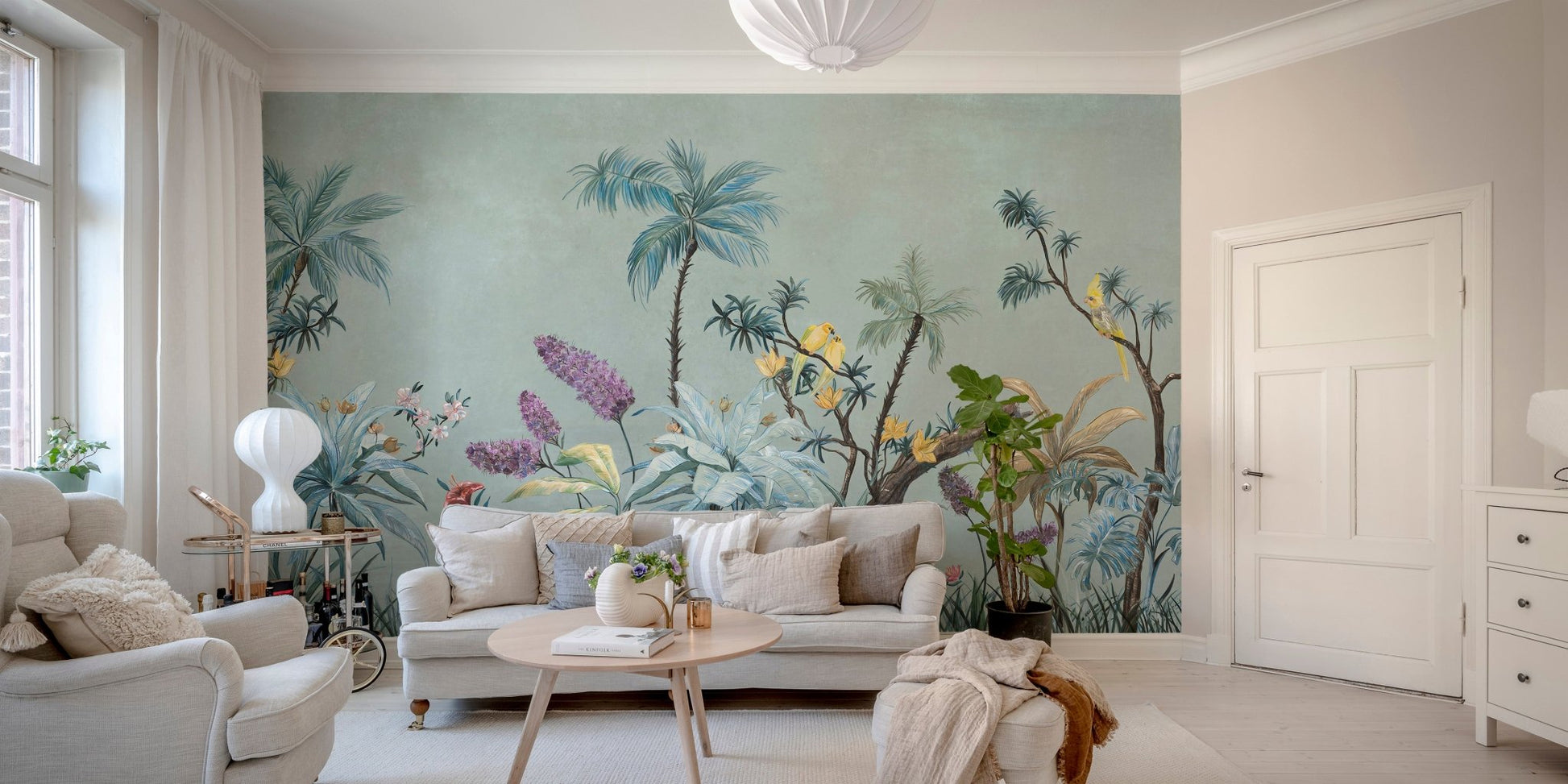 Minimalist sitting area with green botanical wall mural and wooden flooring.