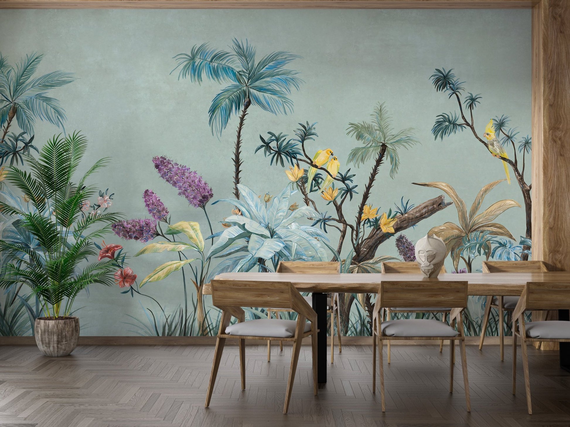 Dining area featuring green tropical wall mural and light wood chairs.