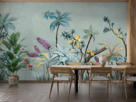 Dining area featuring green tropical wall mural and light wood chairs.