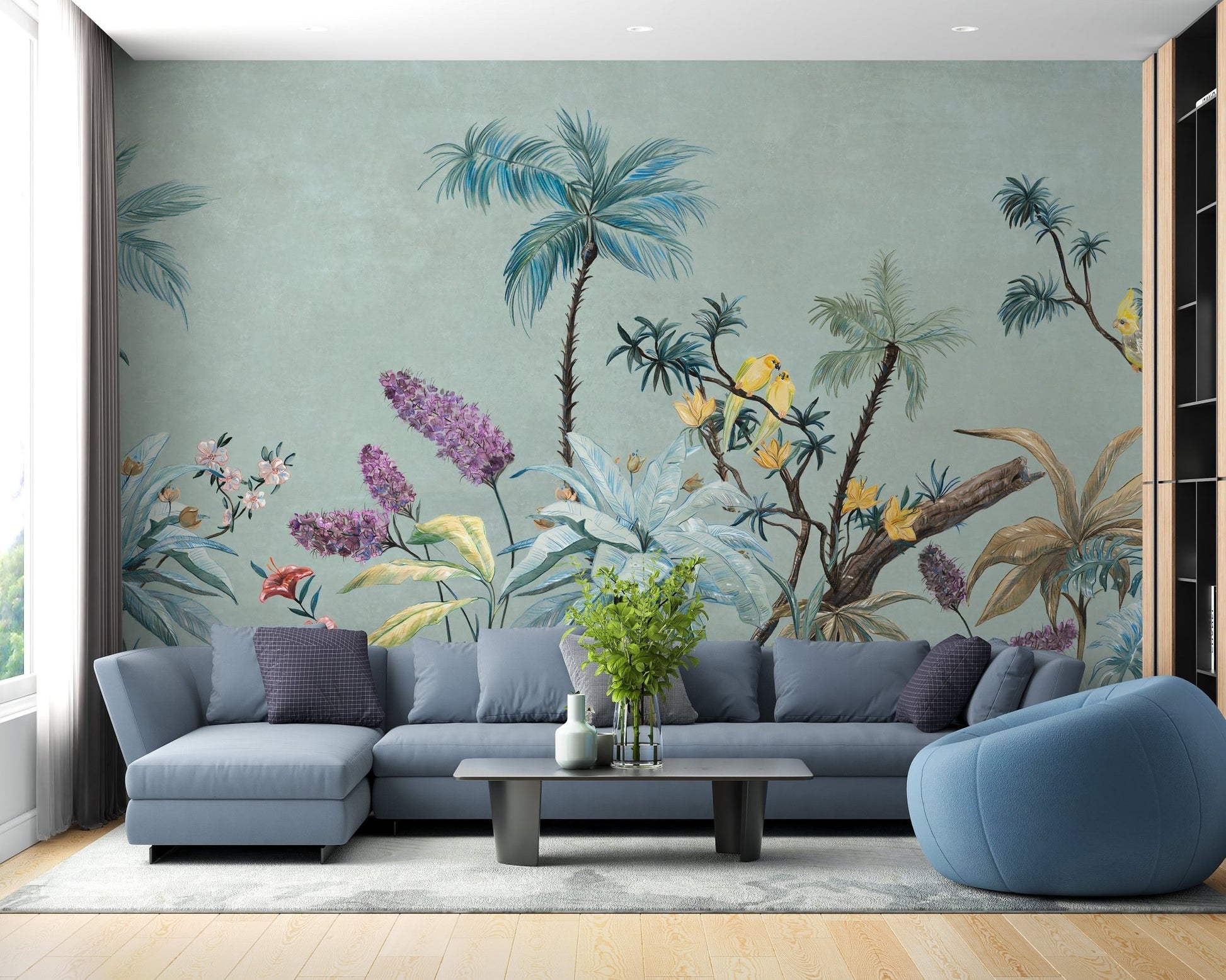 Open plan living room with sage green botanical wall mural and blue couch.