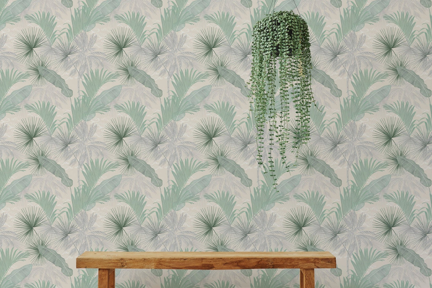 Green Banana Leaves Seamless Pattern Wallpaper behind a wooden bench and hanging plant.