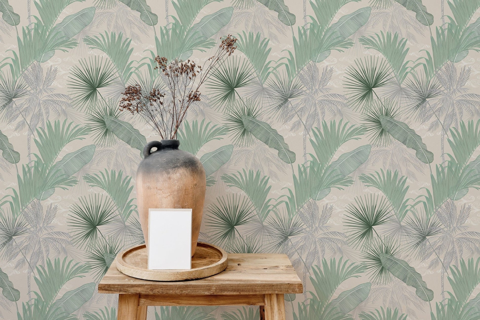 Botanical leaves wallpaper behind a wooden stool and decorative vase.