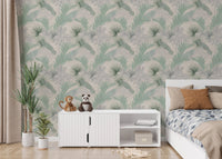 Sage green leaf wallpaper in a bedroom behind a white sideboard and bed.