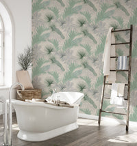 Tropical leaves wallpaper in a bathroom featuring a white freestanding bathtub.