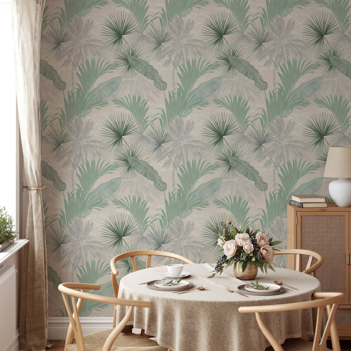 Sage green wallpaper in a dining room with a round table and wooden chairs.