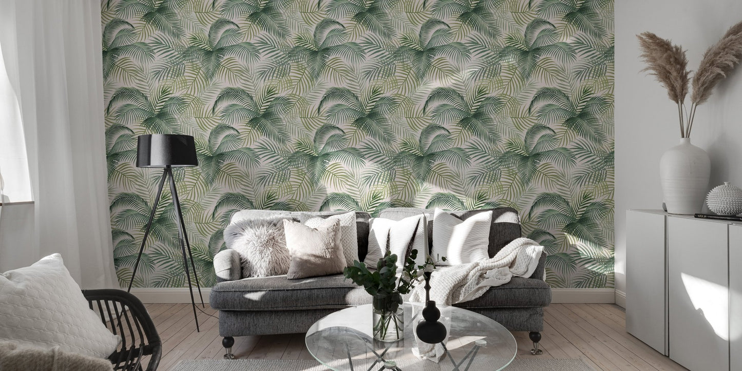 Tropical leaf wallpaper in a spacious living area with a grey sofa and white cabinets.