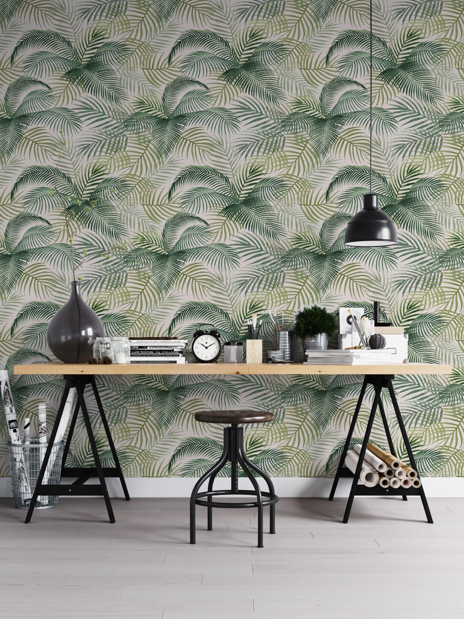 Tropical pattern wallpaper in a home office with a black industrial desk.