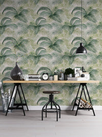 Tropical pattern wallpaper in a home office with a black industrial desk.