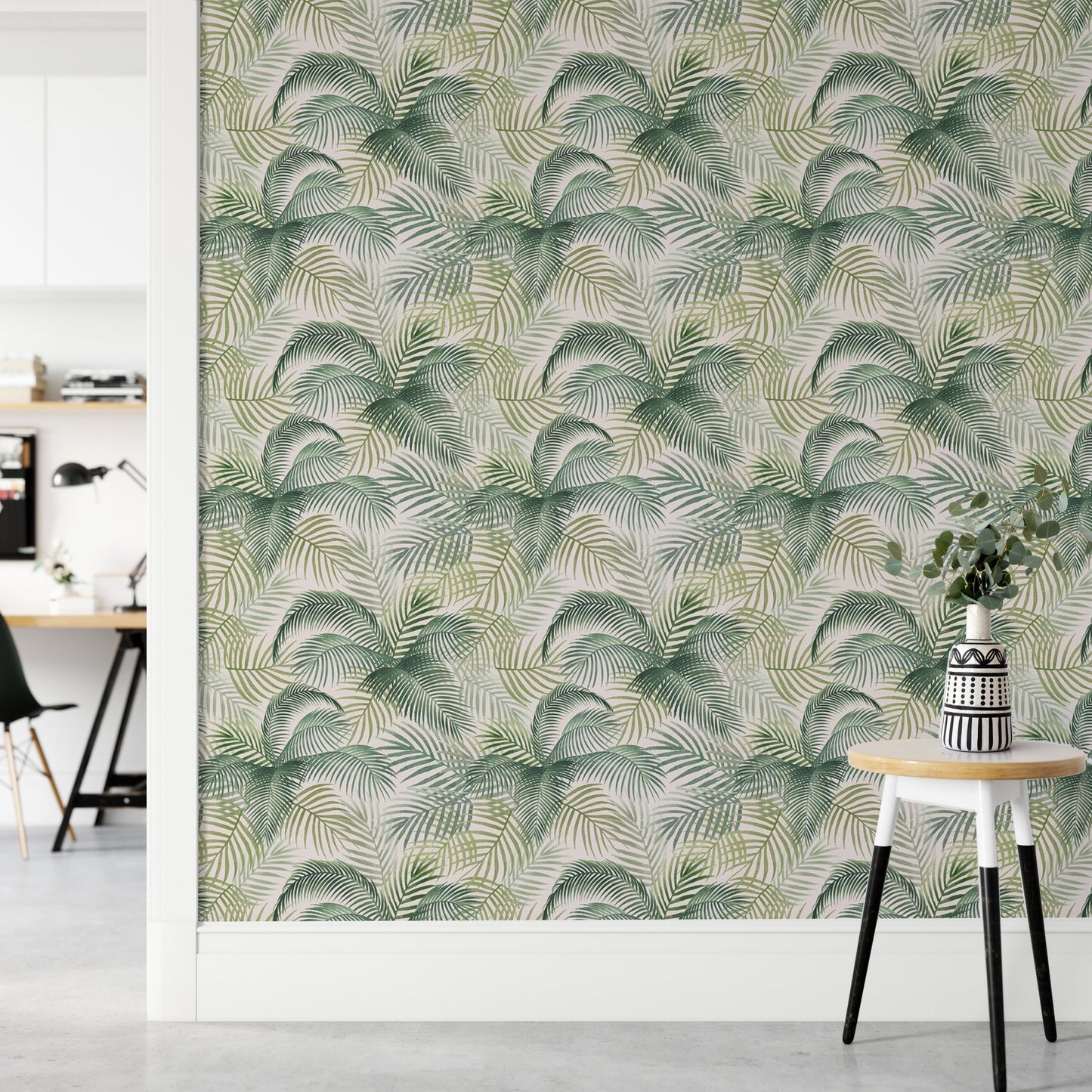 Green leaf wallpaper in a modern workspace with a small wooden side table.