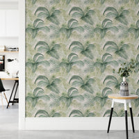 Green leaf wallpaper in a modern workspace with a small wooden side table.