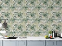 Botanical repeat pattern wallpaper in a white kitchen above a marble countertop.