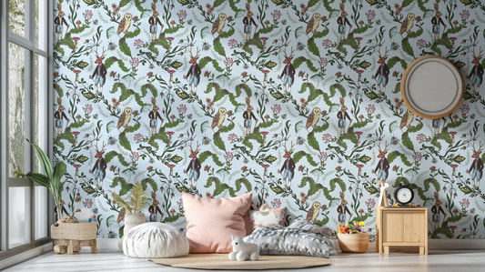 Green leaves with rabbit and owl wallpaper in a kids bedroom with pink pillows.