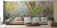 Large tropical plant wall mural behind a brown leather sofa in a living area.