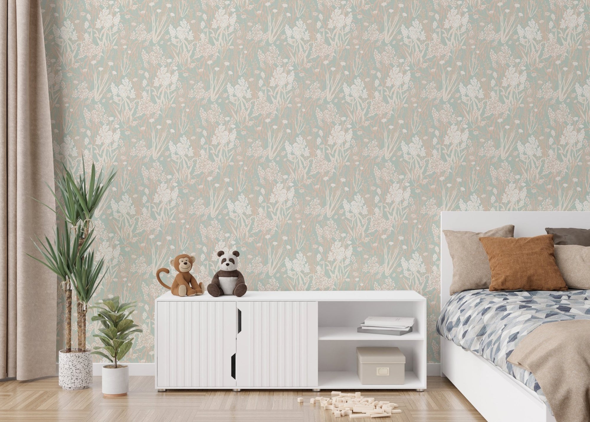 Green botanical leaf pattern wallpaper in a kids bedroom with white cabinets.