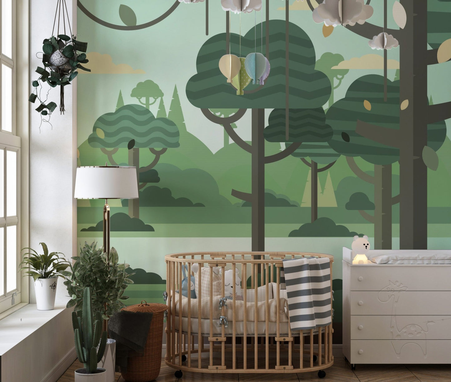 Modern nursery with a wooden crib and green forest botanical wall mural.