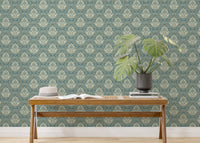 Damask design wallpaper in a bright entryway with a wooden bench and plant.