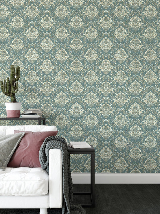 Green Vintage Baroque Damask Design Wallpaper in a living room with a white sofa.