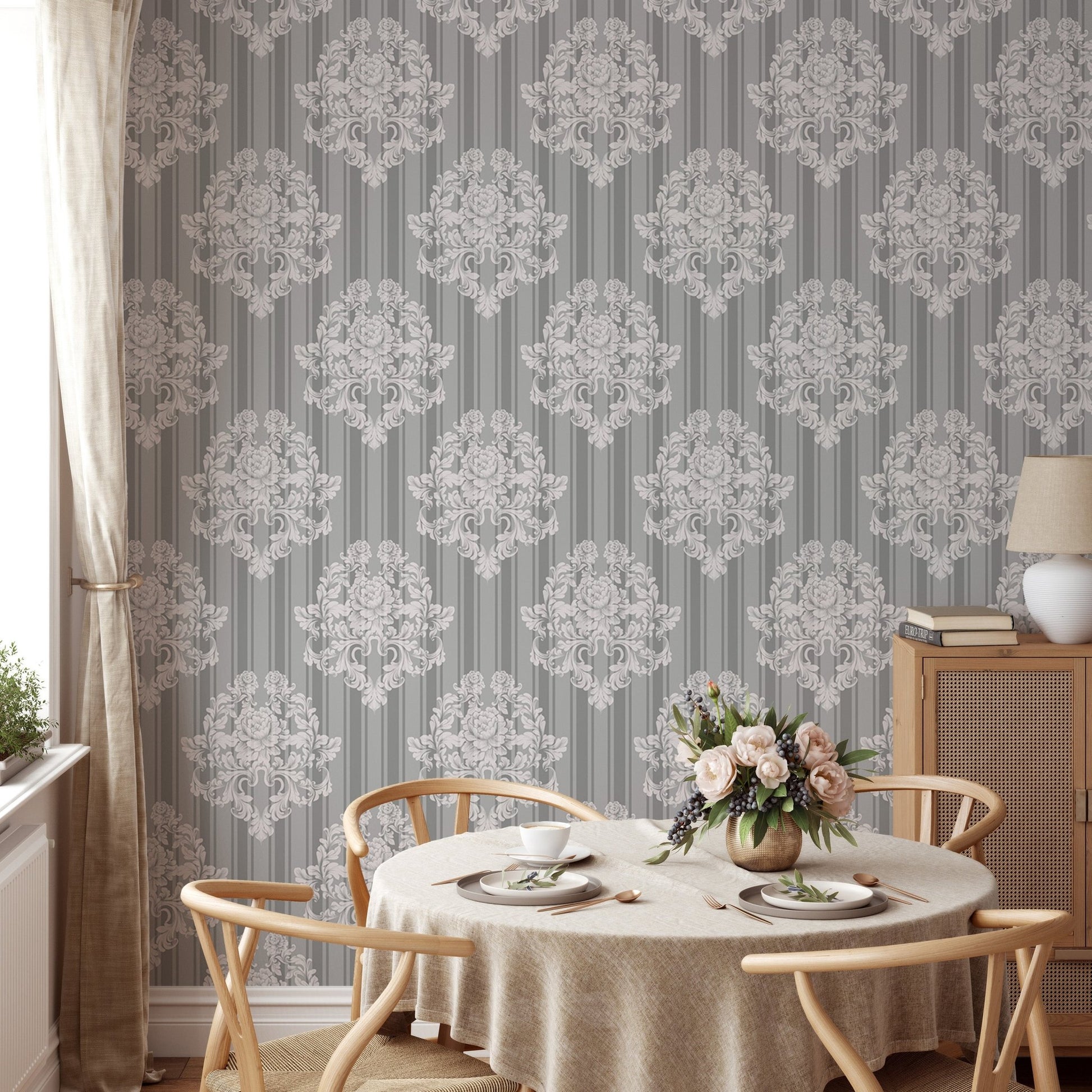 Damask wallpaper on a dining room feature wall with a round table.