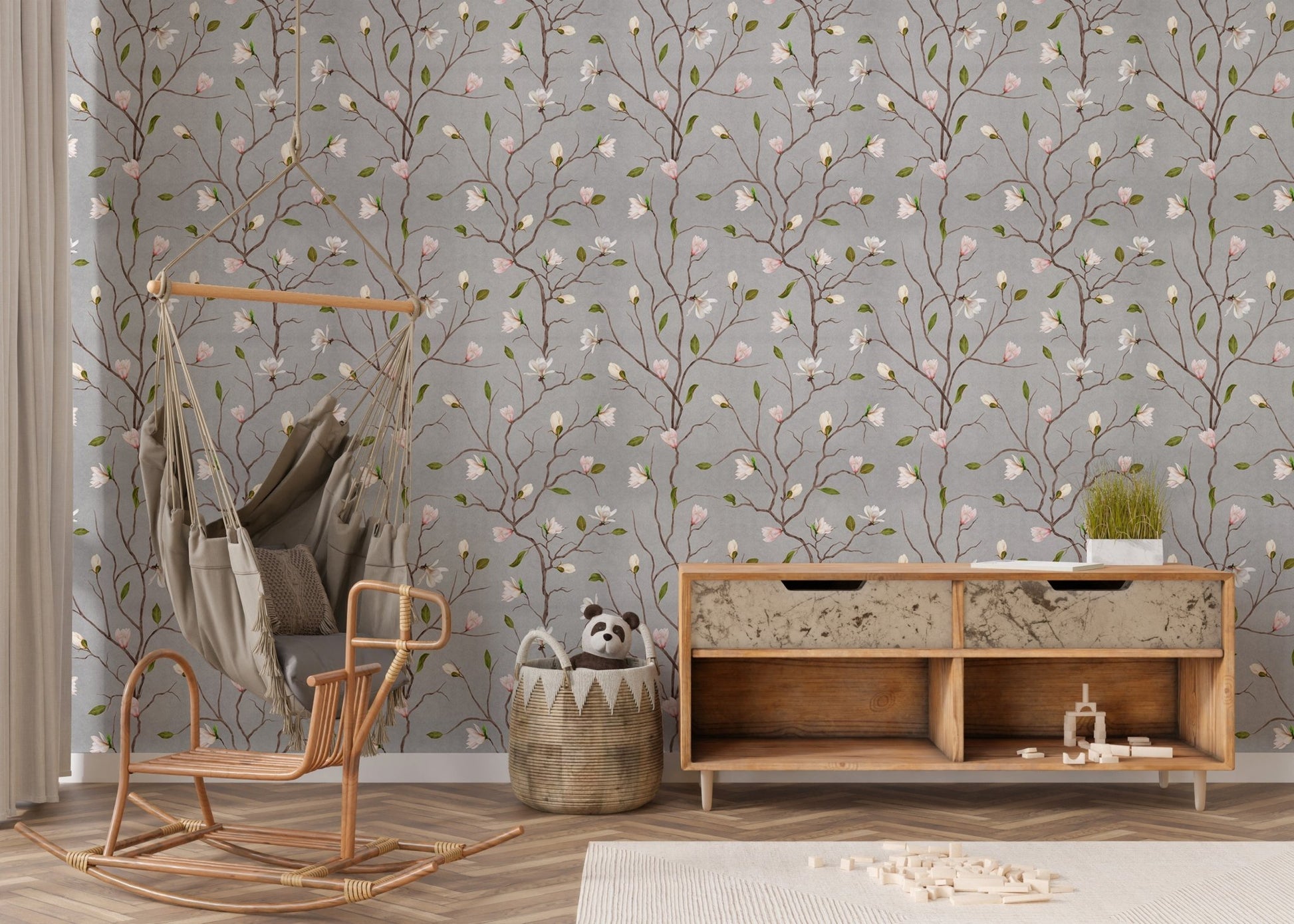 Chinoiserie wallpaper with pink flowers behind a wooden rocking chair.