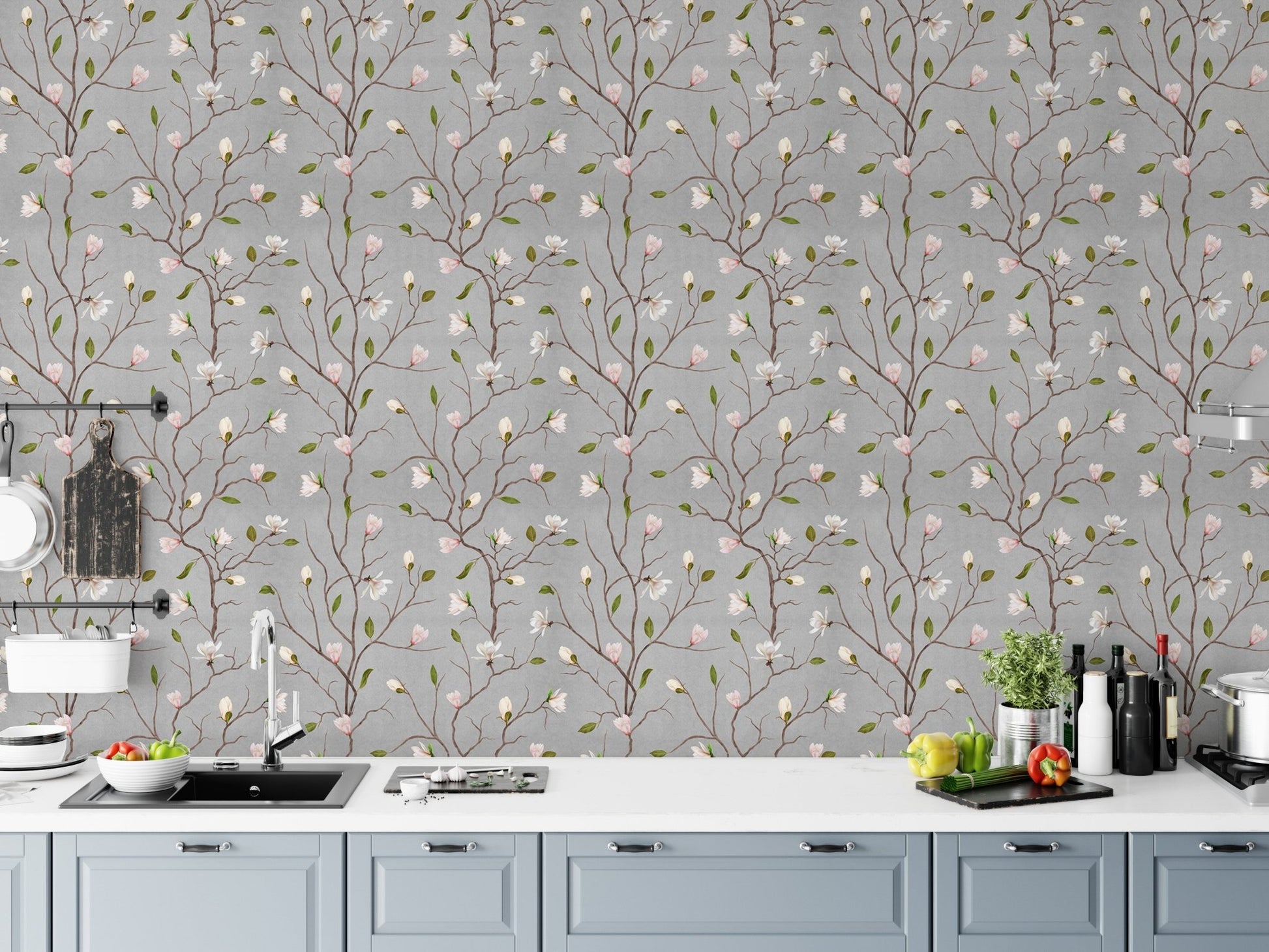 Magnolia blossom wallpaper behind a white kitchen counter with fresh vegetables.